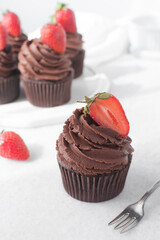 Sticker - Chocolate cupcake with dark chocolate buttercream and strawberries, double chocolate cupcakes with american buttercream, tall swirl frosting on a cupcake with a strawberry