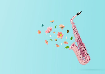 Composition made of pink saxophone retro style with colorful summer flowers and green leaves against pastel blue background. Minimal nature concept.Trendy collage, creative art minimal aesthetic