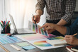 © Phimwilai - Engineers, graphics, architects and painters are meeting to discuss and record details about paint textures. The color tone on the color sheet to match the appropriate structure plan.