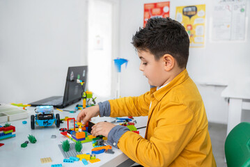 Wall Mural - robotics programming class. children construct and code robot. stem education using constructor bloc