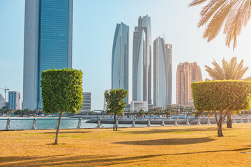 Wall Mural - park in Abu Dhabi is a lush green oasis nestled amidst the towering skyscrapers that line the city's coastline. Lined with rows of palm trees, providing a refreshing respite