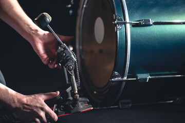 Bass drum and drummer, musical instrument on black background.