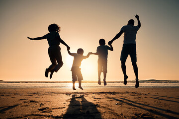 Beach silhouette, sunset and a family jump for freedom, summer energy or travel. Happy, nature and back of a mother, father and children holding hands while jumping at the ocean for celebration