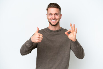 Wall Mural - Young blonde caucasian man isolated on white background showing ok sign and thumb up gesture