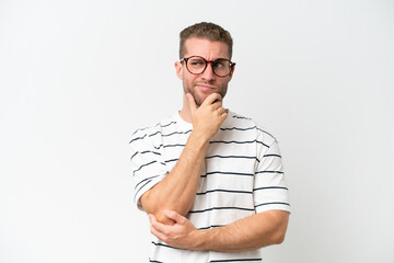 Young handsome caucasian man isolated on white background having doubts and thinking