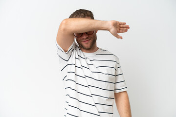 Wall Mural - Young handsome caucasian man isolated on white background covering eyes by hands