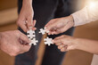 © Phindulo T/peopleimages.com - Business people, hands and puzzle piece in planning, collaboration or teamwork brainstorming at the office. Hand of group in team building, strategy or activity for engagement, support or interaction