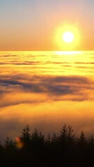 Canvas Print - Calm vertical shot of a mesmerizing sunrise over the fluffy clouds in the highlands