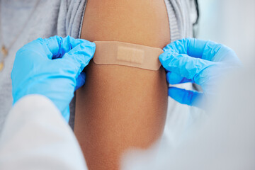 Wall Mural - Person, arm closeup and covid with a plaster and hands for healthcare and medical injection. Patient and doctor at a clinic or hospital for vaccine with a bandage for virus, health and wellness shot