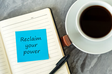 Wall Mural - Cup of coffee and adhesive note on notepad with text reclaim your power