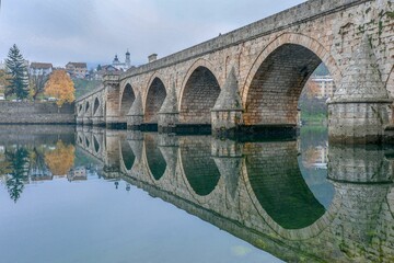 Wall Mural - Beautiful view of Mehmed Pasa Sokolovic Bridge with a reflection on Bosna Drina river