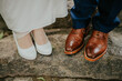 Women's and men's shoes at a wedding are photographed in close-up, soft focus