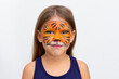 © Tatiana Foxy - Portrait of smiling caucasian girl of six years looking at camera on white background with tiger face painting