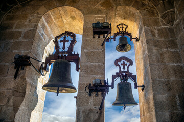 Sticker - Three bells of the bell tower of the co-cathedral of Santa Maria de Caceres, Spain with blue sky background with clouds