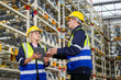 © FotoArtist - Multiethnic industrial workers checking their logistic lists while working with transportation of goods in warehouse