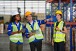 © FotoArtist - Multiethnic industrial workers checking their logistic lists while working with transportation of goods in warehouse