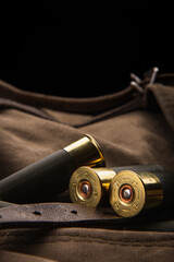 shotgun shells close-up. ammunition for smoothbore weapons on a khaki canvas backpack. dark back