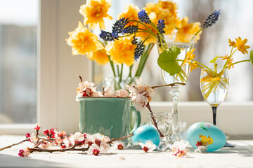 easter concept. various spring flowers and colored easter eggs. delicate light photo with soft artis