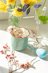 easter concept. various spring flowers and colored easter eggs. delicate light photo with soft artis