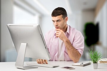 Poster - young business male working on computer