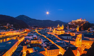 Beautiful view of the historic city of Salzburg with Salzburg Cathedral and famous Festung Hohensalzburg illuminated in beautiful twilight in Salzburger Land, Austria