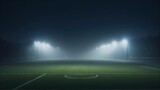 Fototapeta Sport - A soccer field being lit by huge bright spotlights, stadium.