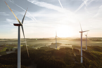  Wind turbines with low angle sunrise backlight seen from an aerial view