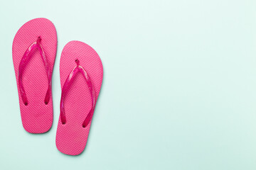 Wall Mural - Bright flip flops on color background, top view