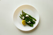 Ready asparagus on a white plate ready to eat, healthy food for the body, source of antioxidants.