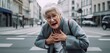 © oleksandr.info - Distressed Senior woman Experiencing a heart attack in a street