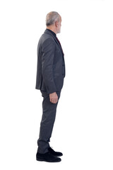 Sticker - side view of a man standing with suit and tie and  look at the bottom on white background