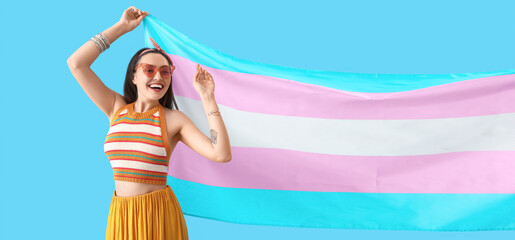 Poster - Young woman with transgender flag on blue background