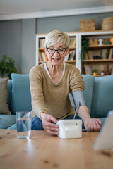 Wall Mural - Senior caucasian woman check blood pressure measure device on hand