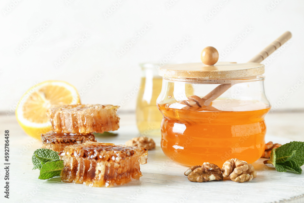 Jar of sweet honey and combs on table