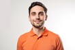 © Robert MEYNER - Portrait of a handsome young man in orange t-shirt on white background
