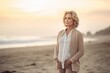 Full-length portrait photography of a pleased woman in her 40s wearing a chic cardigan against a summer landscape or beach background. Generative AI