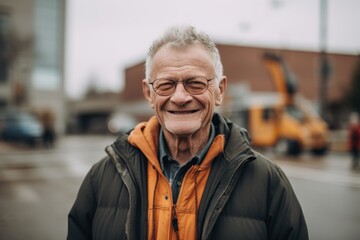 Canvas Print - portrait of smiling senior man in eyeglasses standing on street