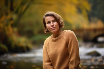 Sticker - Portrait of a beautiful young woman in the autumn forest near the river