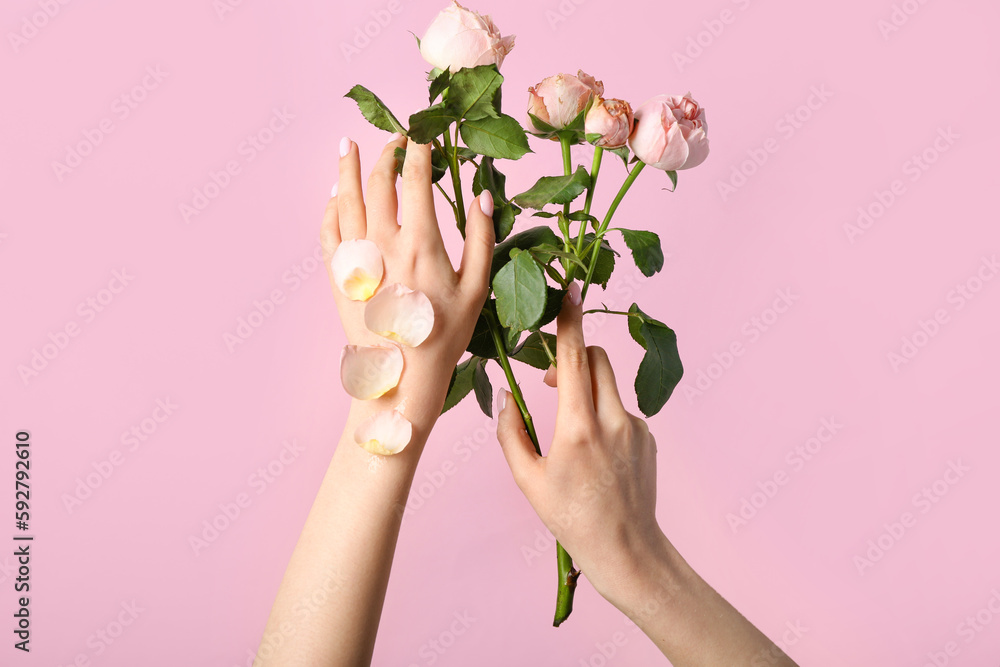 Woman with roses on pink background. Hand care concept