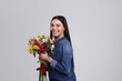 © New Africa - Happy young woman with beautiful bouquet on light grey background