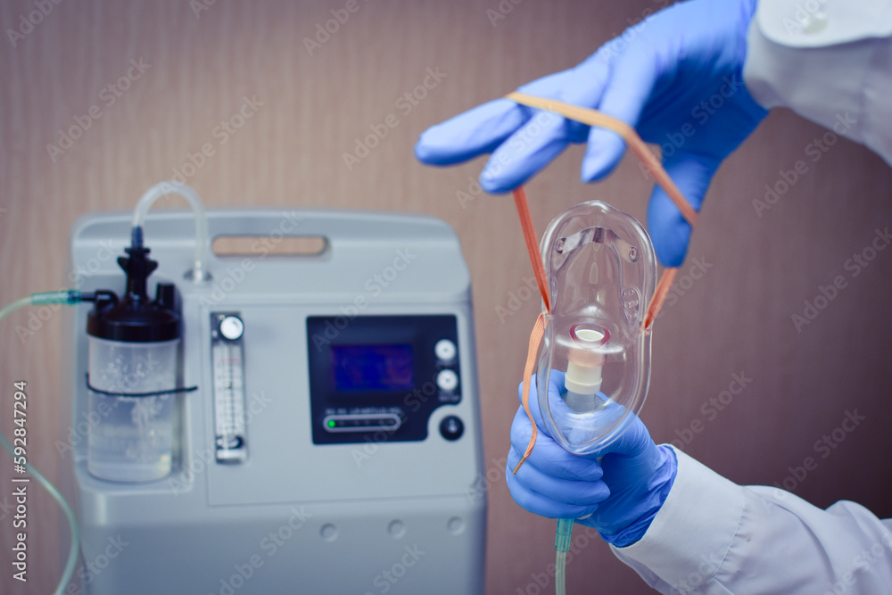 Hold Mask O2 Hands in medical gloves hold out an oxygen mask against the background ...