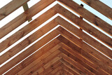 Fototapeta Storczyk - A timber roof truss of a house under construction
