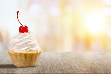 Tasty sweet Vanilla Cupcake on desk