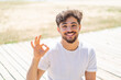 © luismolinero - Handsome Arab man at outdoors With glasses and doing OK sign
