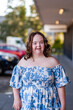 © Austockphoto - Urban portrait of smiling young lady with down syndrome outside shopping centre