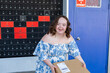 © Austockphoto - Happy young person with a disability holding brown box parcel near post office