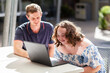 © Austockphoto - happy young lady with down syndrome working on laptop getting assistance with personal activities
