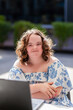 © Austockphoto - Happy portrait of young person with a disability sitting at laptop