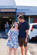 © Austockphoto - Smiling portrait of teen girl with down syndrome in community near shops with her provider