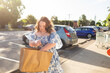 © Austockphoto - Teenager with down syndrome in community shopping with brown paper bag
